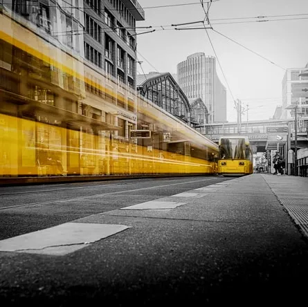 yellow tram on a grayscale background of a metropolitan area