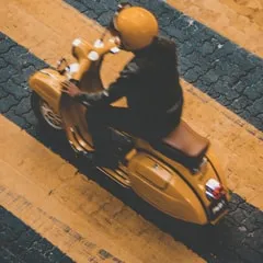 someone holding his smartphone with blurry city lights in the background